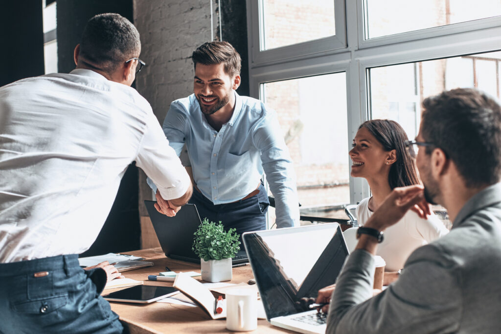 Business colleagues shaking hands in an office